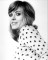 Wendy Richard looking over her shoulder, wearing a blouse printed with small hearts.  Circa 1974.