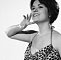 Modeling photo of Wendy Richard in a brief leopard print swimwear; cinched at the waist