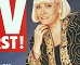 Wendy Richard in gold and black jacket and black slacks and high heels