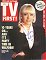 Wendy Richard, dressed elegantly in white blouse, pearls, and black blazer