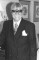 Wendy Richard, dressed dapperly, in double-breasted suit and tie.