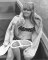 One of four photos of Wendy Richard sitting in a boat