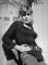Wendy Richard leaning against a tree
