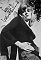 Wendy Richard leaning against a tree