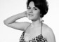 Modeling photo of Wendy Richard in a brief leopard print swimwear; cinched at the waist.