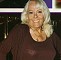 Wendy Richard, smiling wearing a stylish, yet casual black outfit