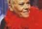 Wendy Richard as Pauline in short hair and red boa feathers, mid-2005