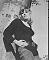 Wendy Richard leaning against a tree
