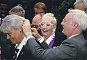 John Inman adjusting Wendy Richard's hair braid, as Sue Pollard looks on.