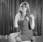 Wendy Richard wearing a sleeveless mini-dress and long blonde wig during a photo-session, 1966.