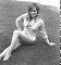 Wendy Richard reclining on grass, wearing a blue and white striped shirt - 1972