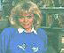 Wendy Richard, dressed in jeans and a blue sweatshirt, sits surrounded by her frog
				 collection